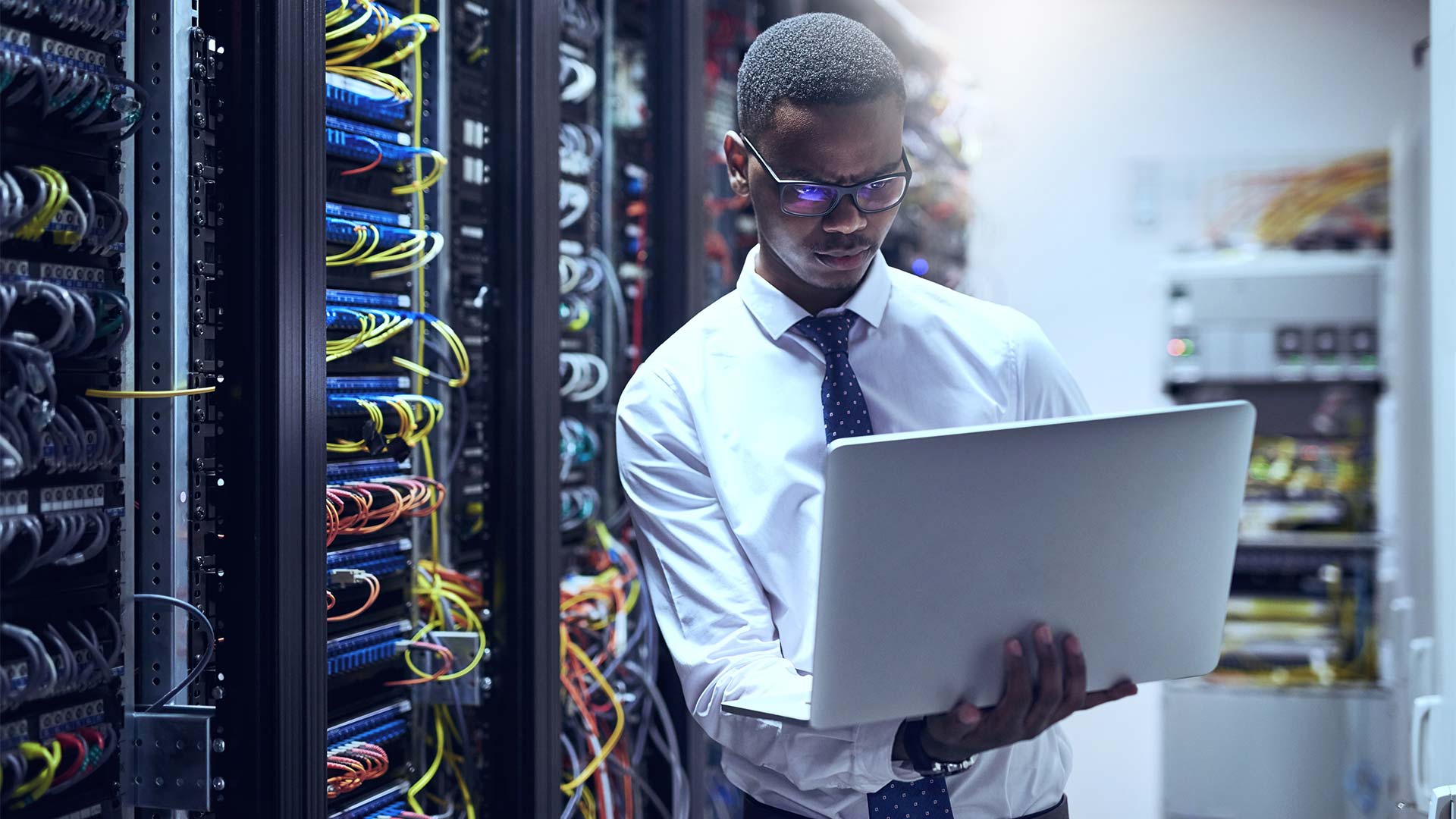 man using a laptop in datacenter