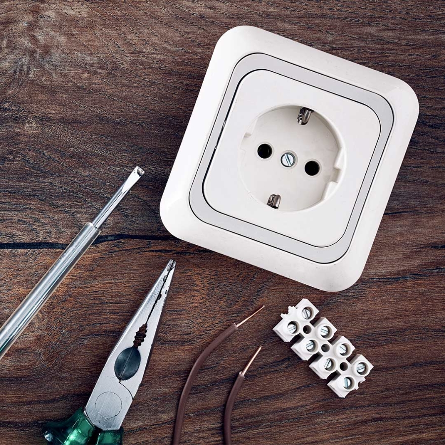 Set of electrical work tools on wooden table background