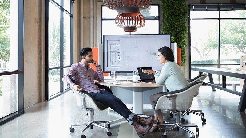 Two working professional discussing in office