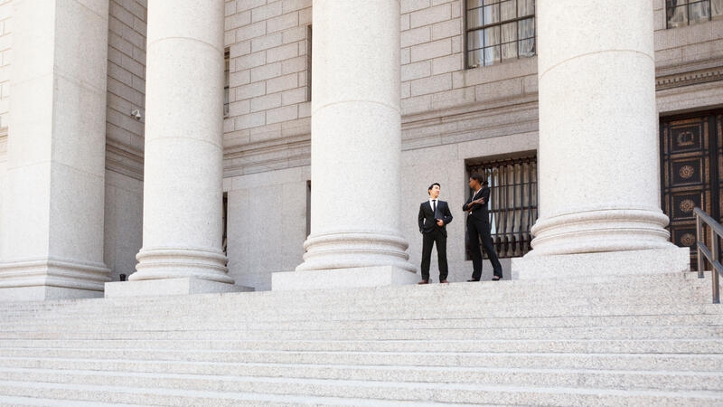 people talking at a government building