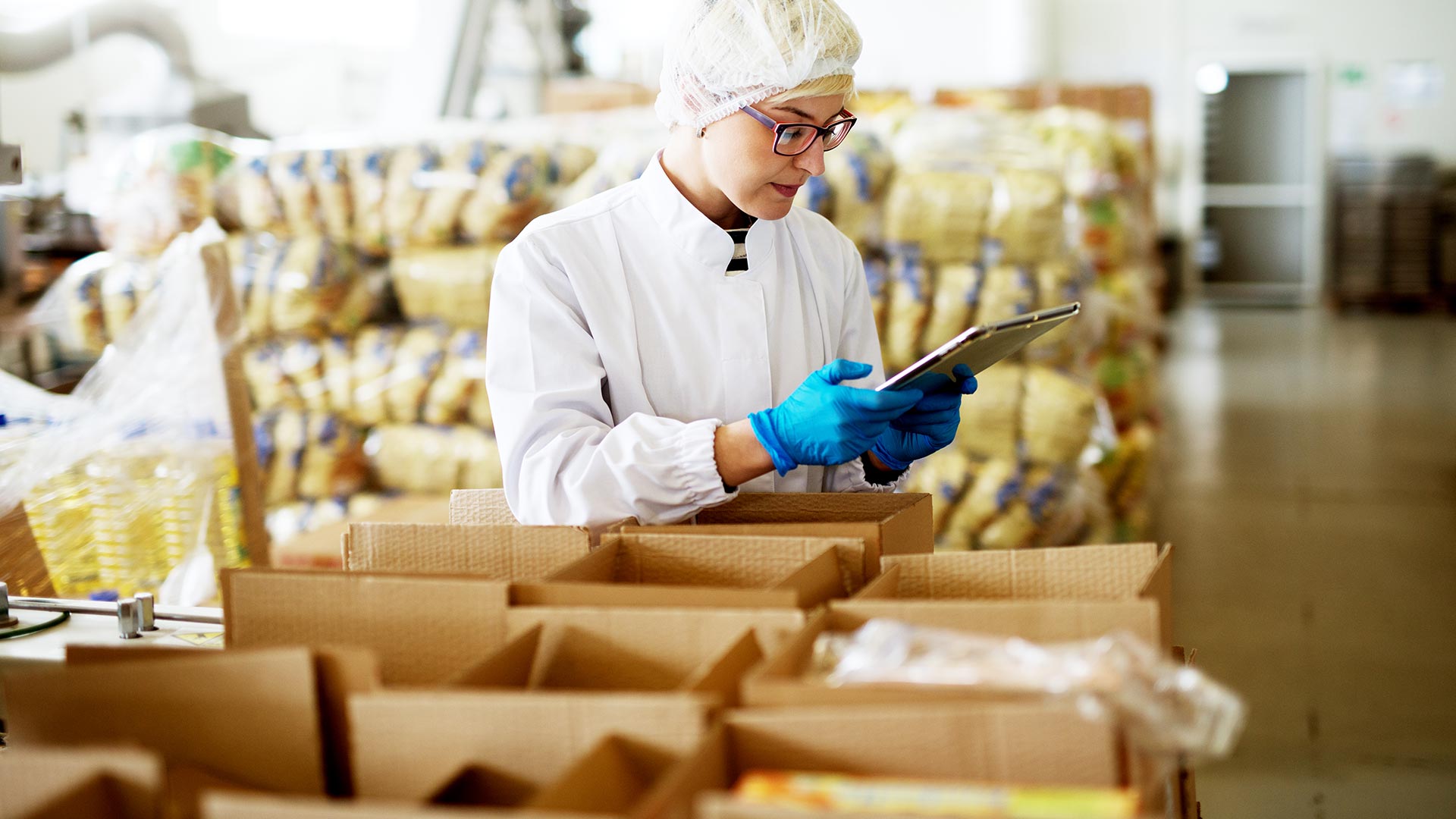 female worker in sterile clothes is using a tablet