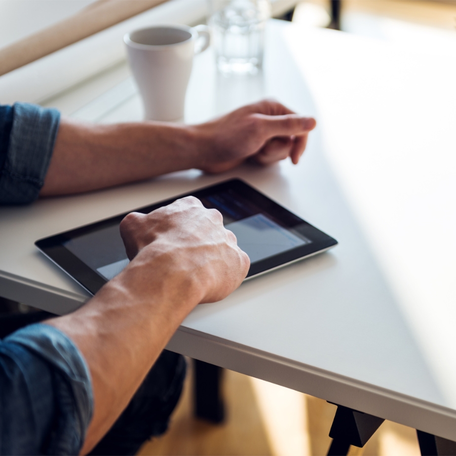 man working with tablet in table